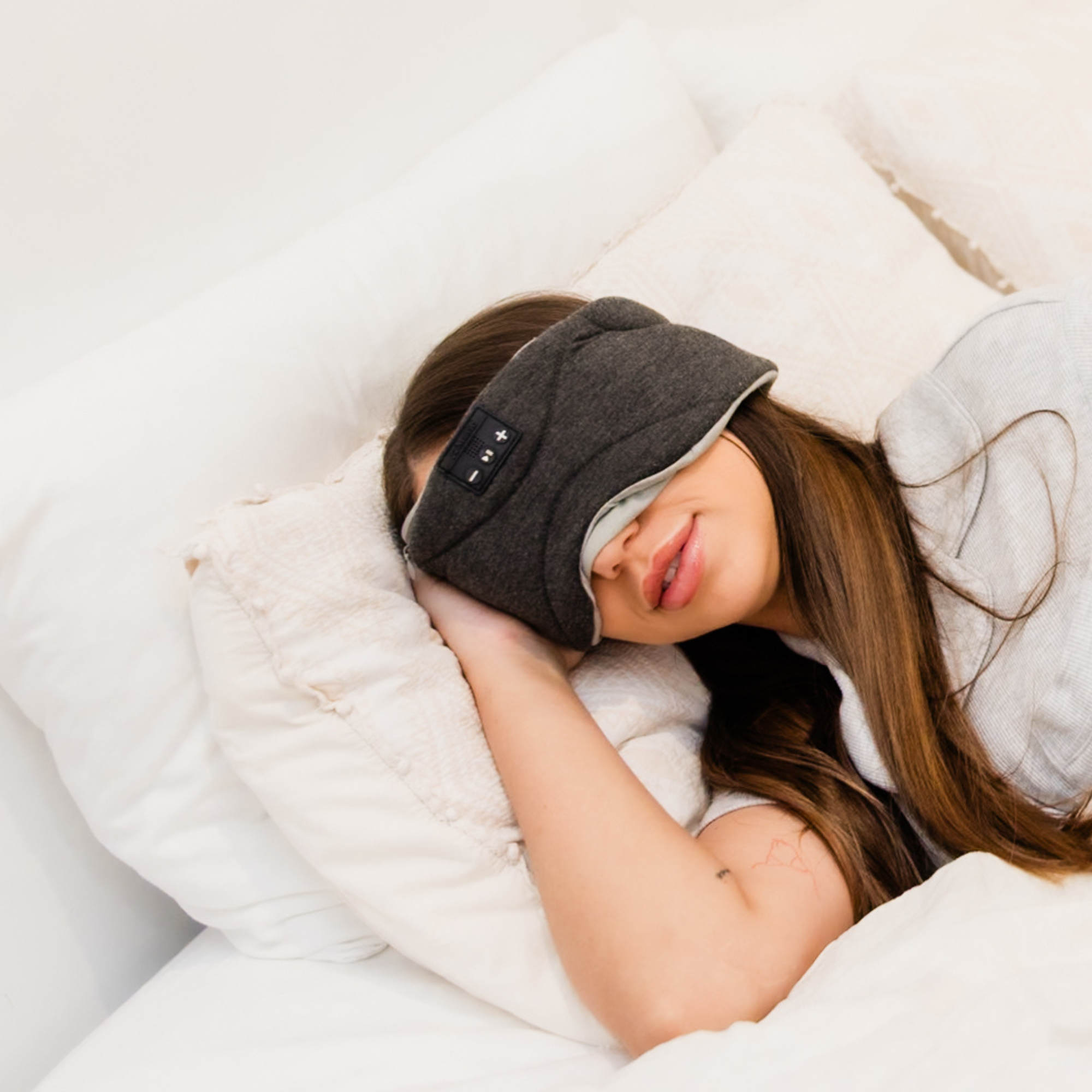 Woman wearing Somny sleep mask side sleeper position - full blackout sleep mask with built-in speakers Australia