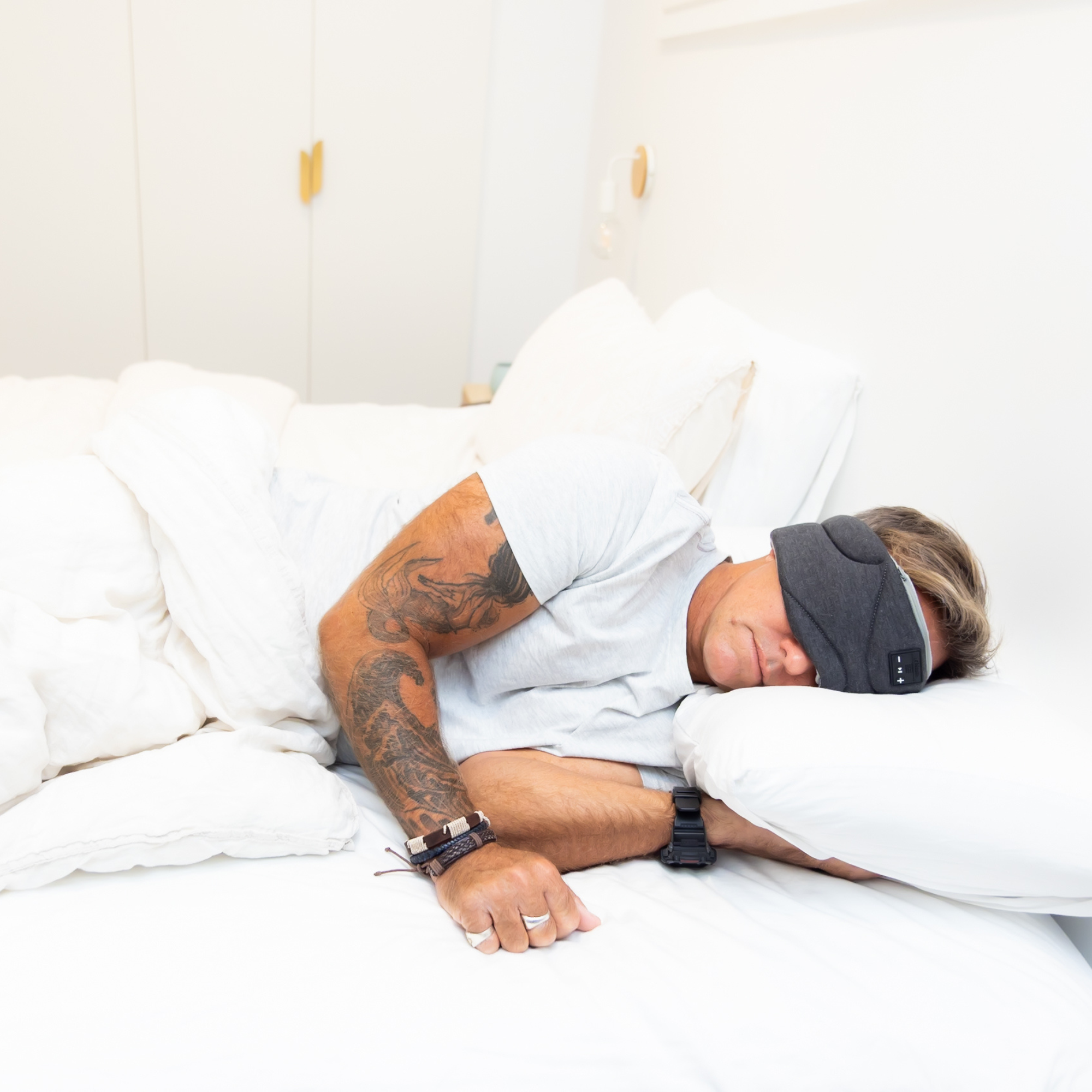 Somny sleep system lifestyle - man sleeping deeply with multi-sensory sleep mask Australia