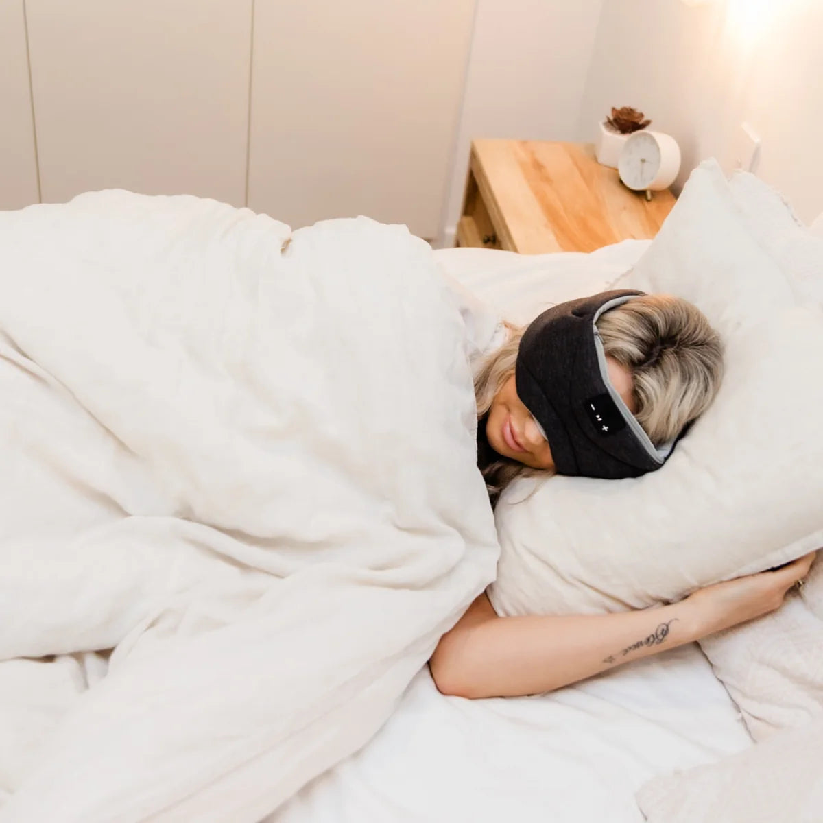Side sleeper resting in the Somny Solutions sound sleep mask